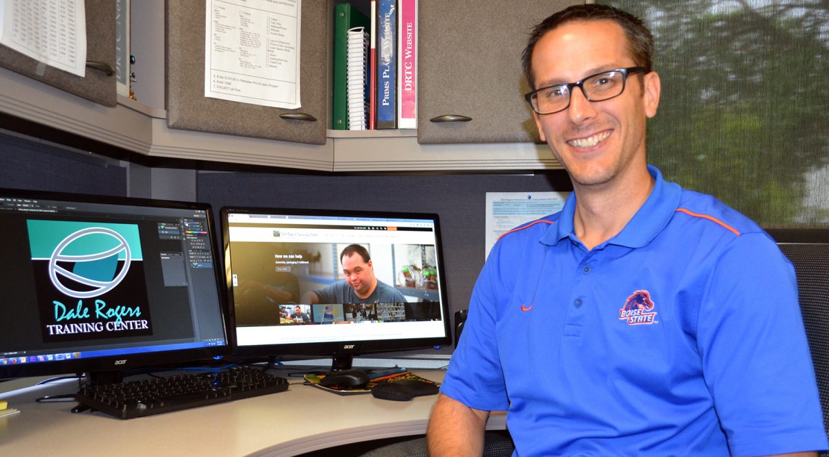 James Helm, public relations coordinator at DRTC, sitting at his desk.